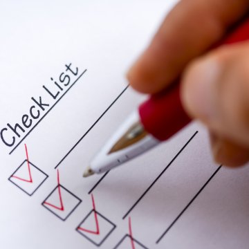 background check services truthfinder money price cost hand with pen in red checking check list boxes